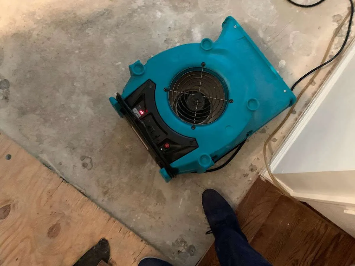 Air mover drying subfloor during Leak Detection & Repair in Connellsville